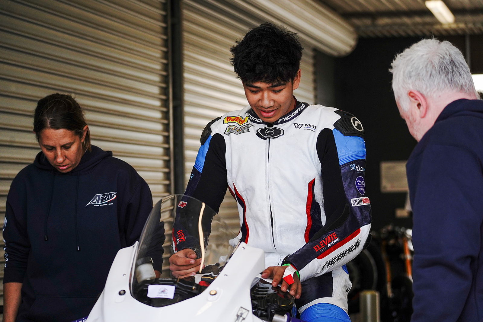 Alvin Wu and Apex Racing Team crew preparing a race bike in the Phillip Island garage.